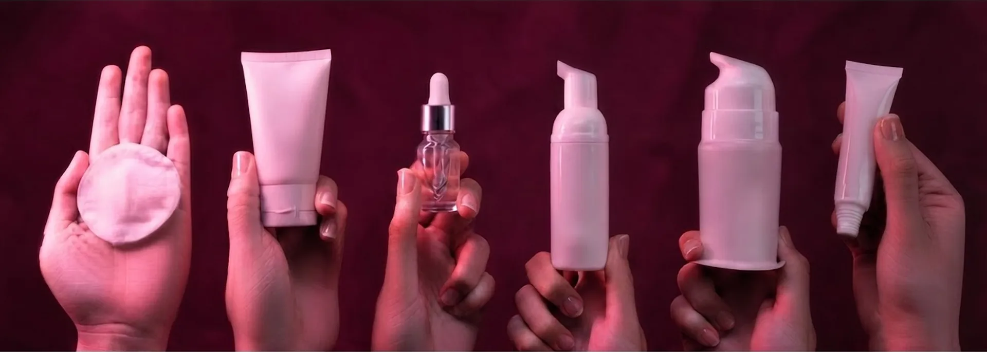 Hands holding various cruelty-free beauty products